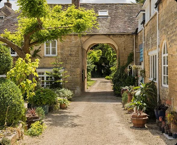 The stone archway entrance to Upper Court holiday cottages