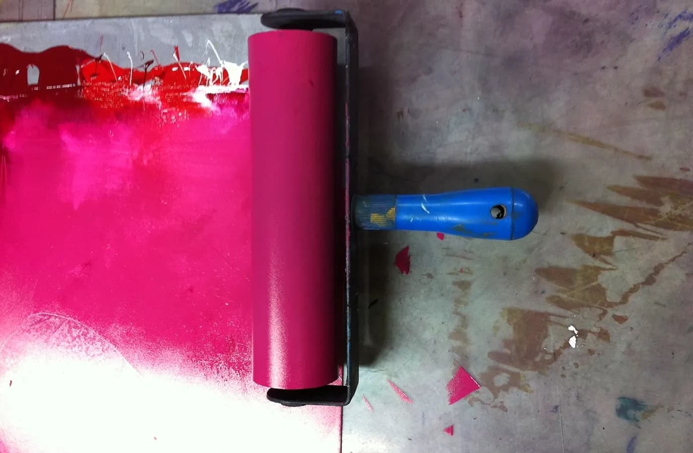 Bright pink ink roller for a printmaking session
