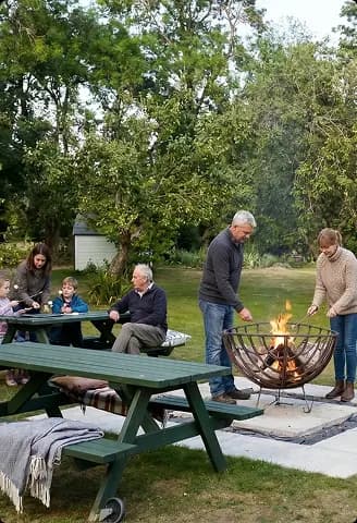 Guests gathered around an outdoor fire pit at Upper Court