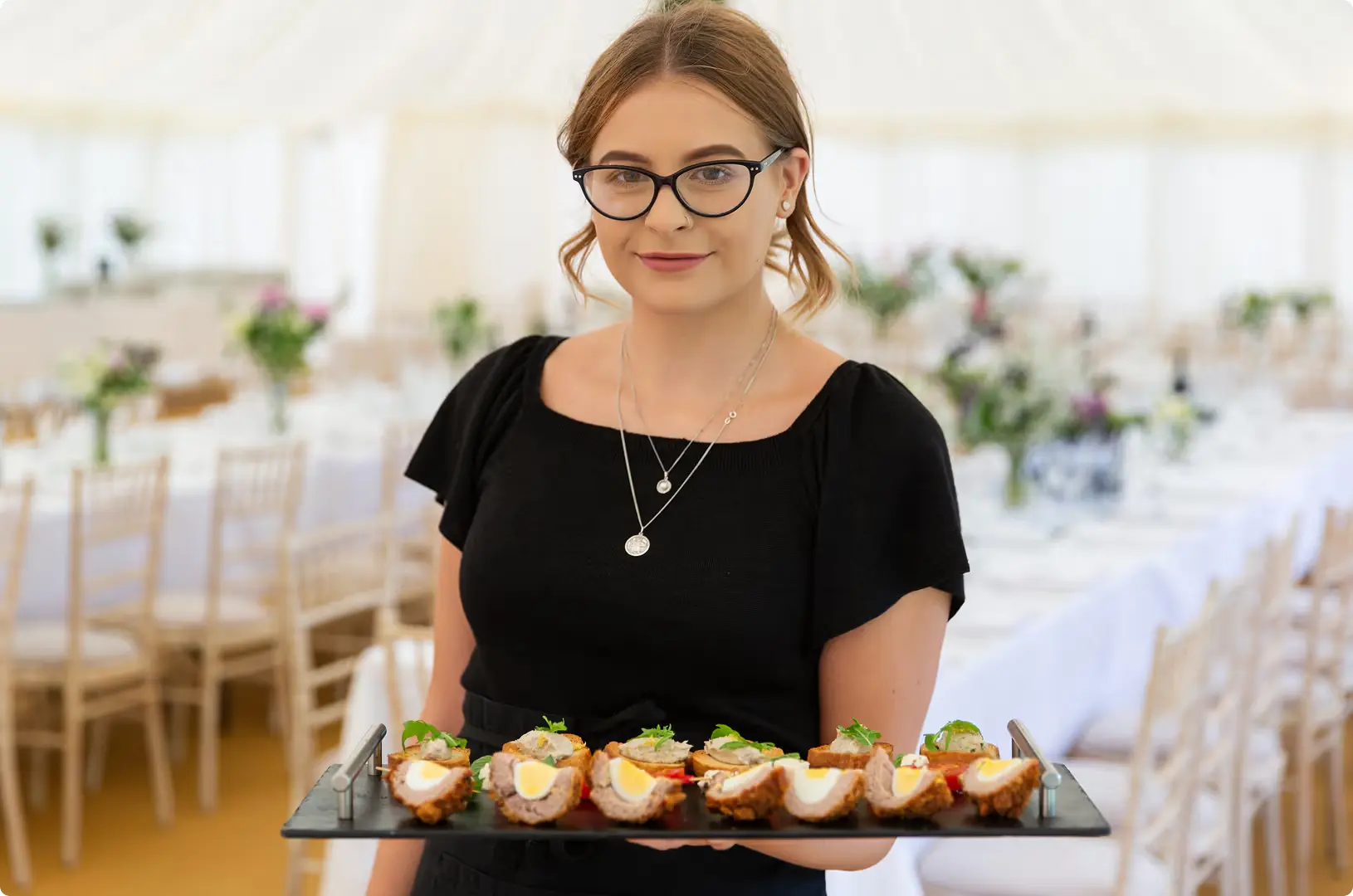 An elegantly set dinner table with colourful flower centrepieces at Upper Court